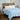 Light blue cooling comforter styled on a bedroom bed