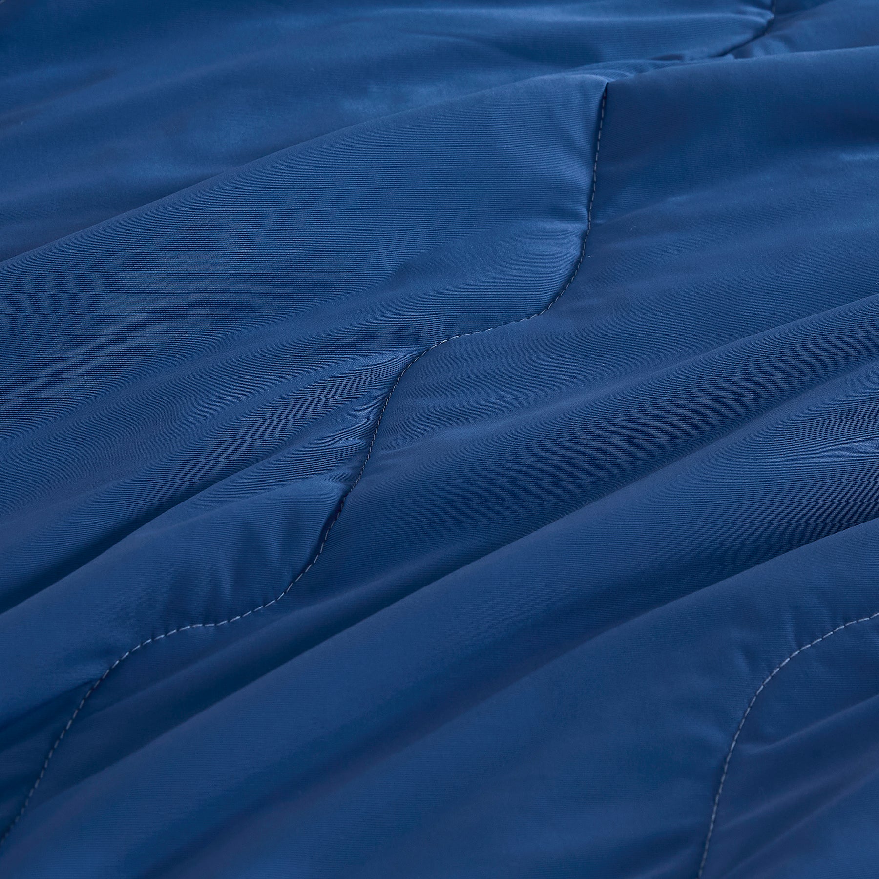 Close-up of breathable cooling comforter fabric in blue