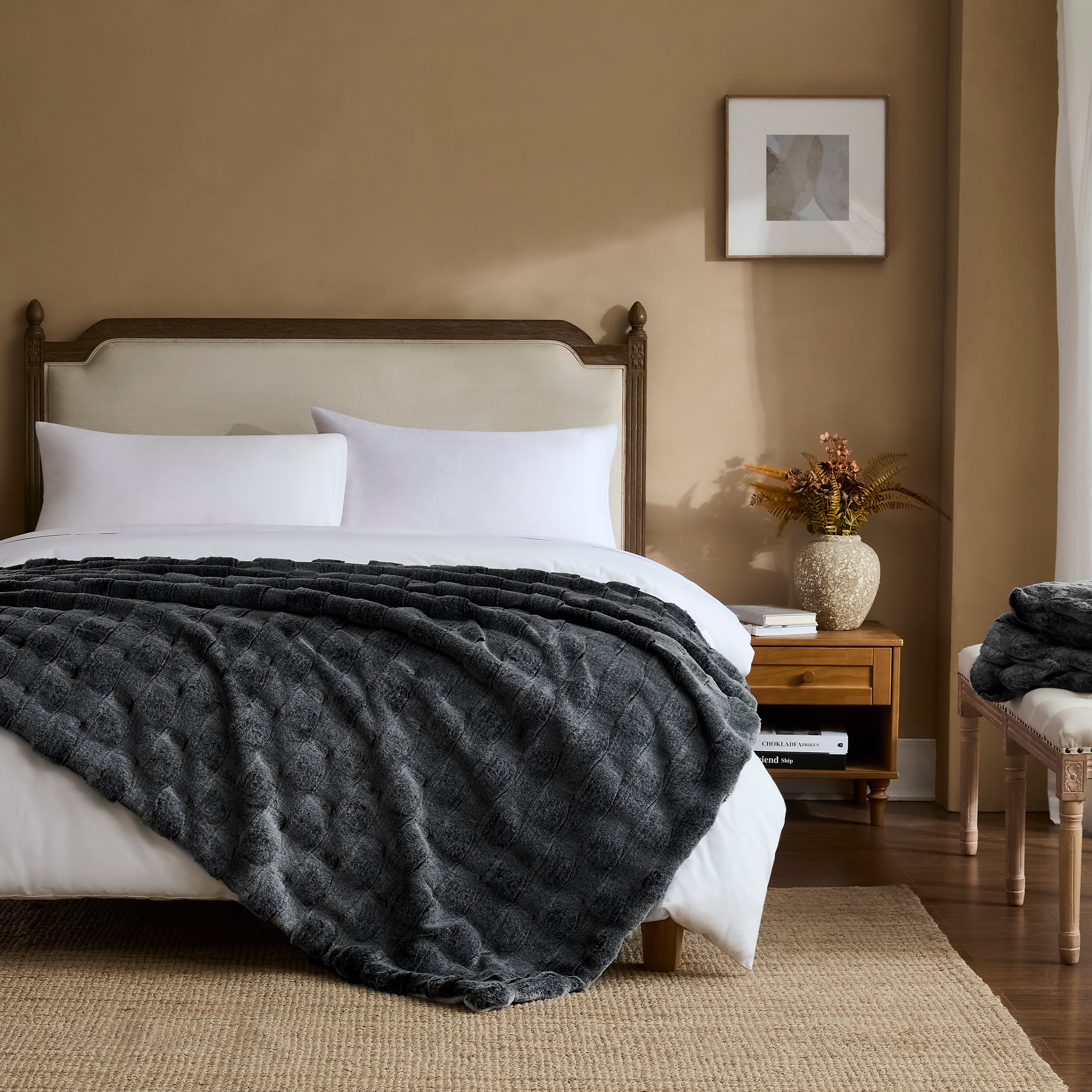 Charcoal ripple plush blanket styled on a bedroom bed
