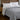 Gray cooling comforter styled on a bedroom bed