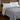 Gray lightweight cooling comforter styled on a bedroom bed