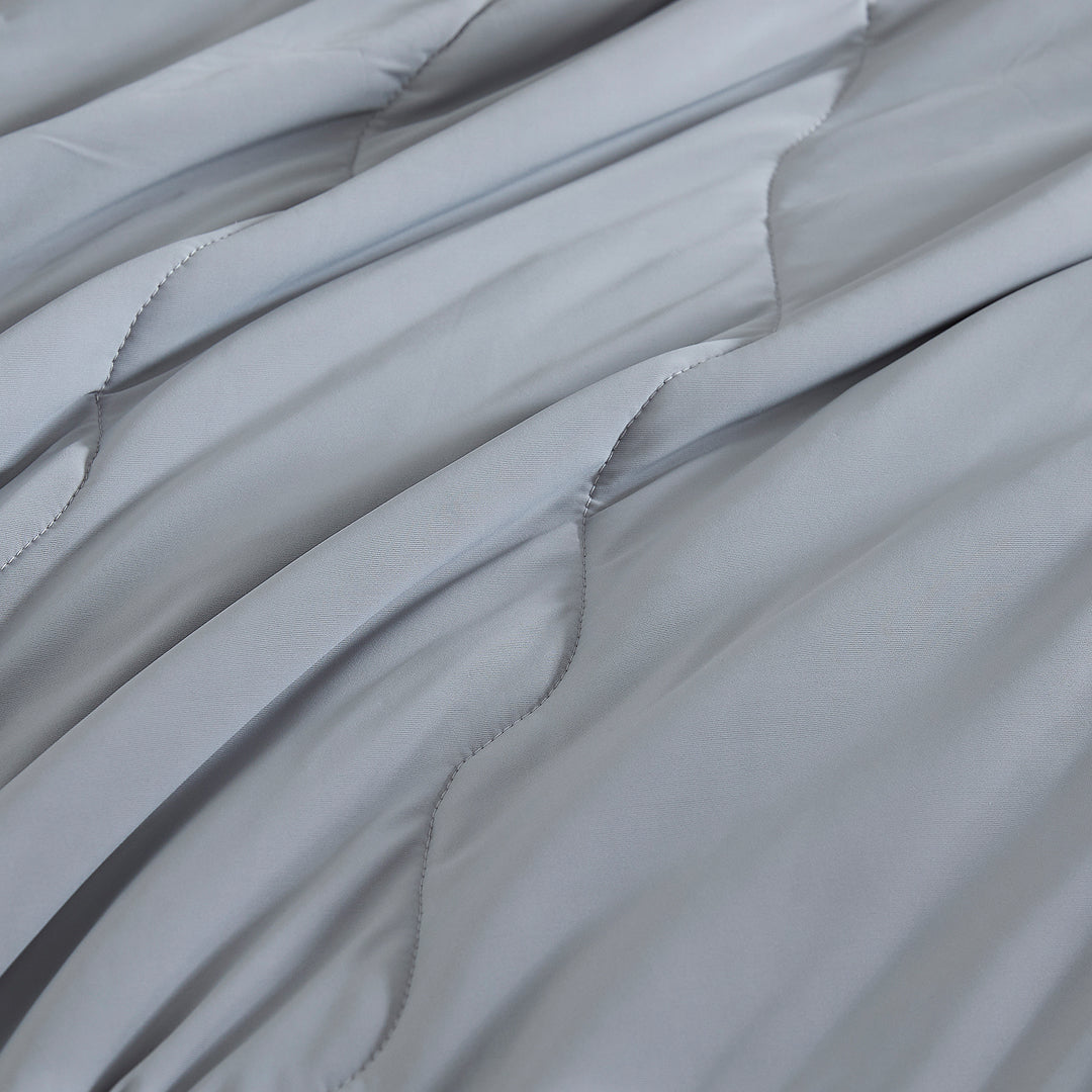 Close-up of gray cooling comforter fabric with smooth quilted texture