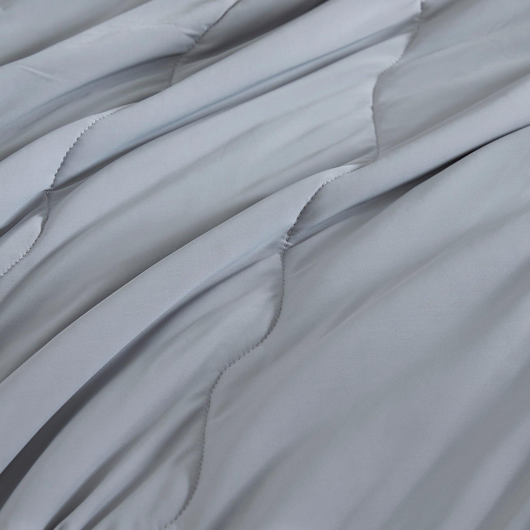 Close-up of lightweight cooling comforter fabric in gray