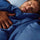 Man sleeping under a navy cooling comforter with smooth cool-touch fabric