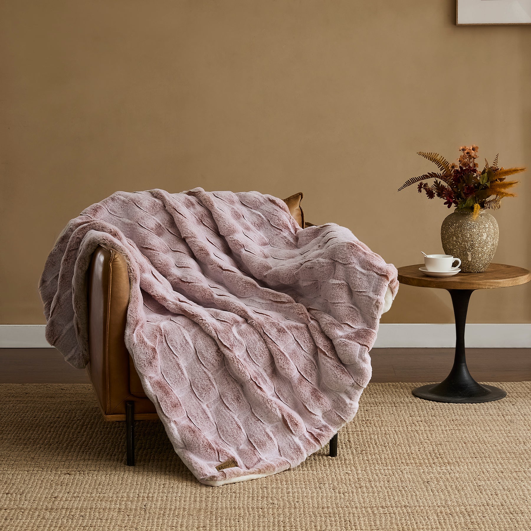 Pink ripple plush blanket draped over a chair