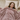 Woman relaxing under a pink ripple plush blanket in bed