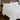 White cooling comforter styled on a bedroom bed